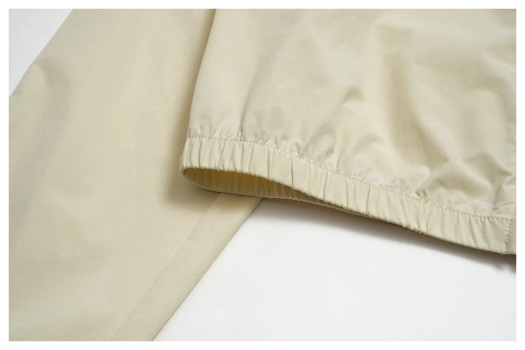 Women’s zip-up athletic jacket, light cream with elastic, ruched hem