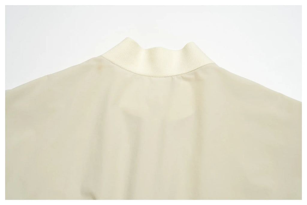 Women’s athletic jacket, light cream with ribbed round neckline and seam lines
