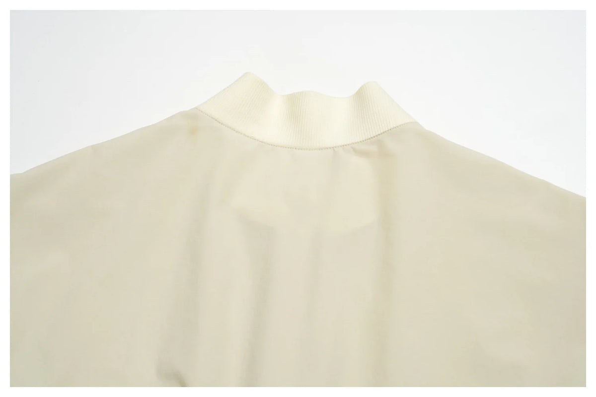 Women’s athletic jacket, light cream with ribbed round neckline and seam lines
