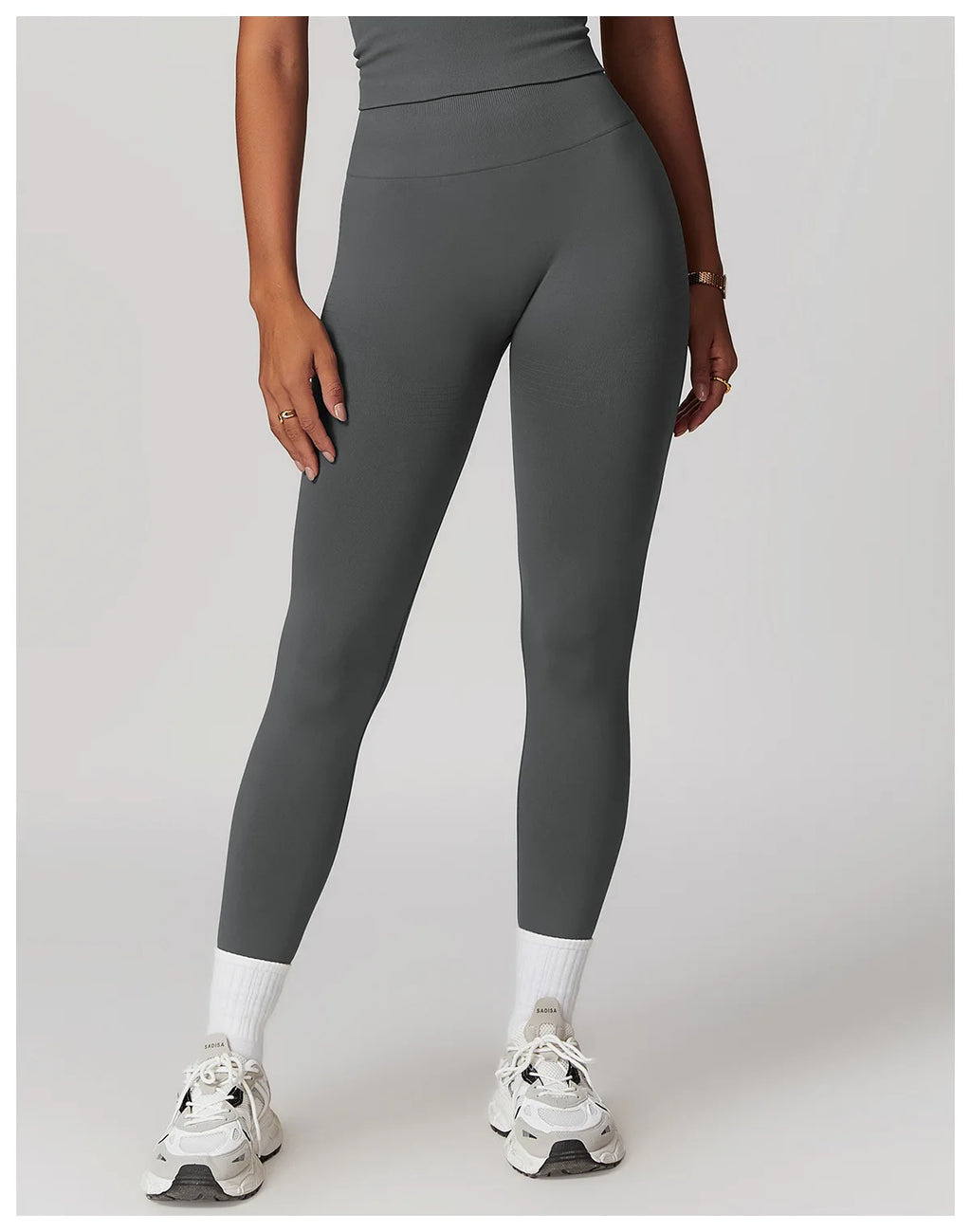 High-waisted active leggings in dark gray, ankle-length with smooth panel design