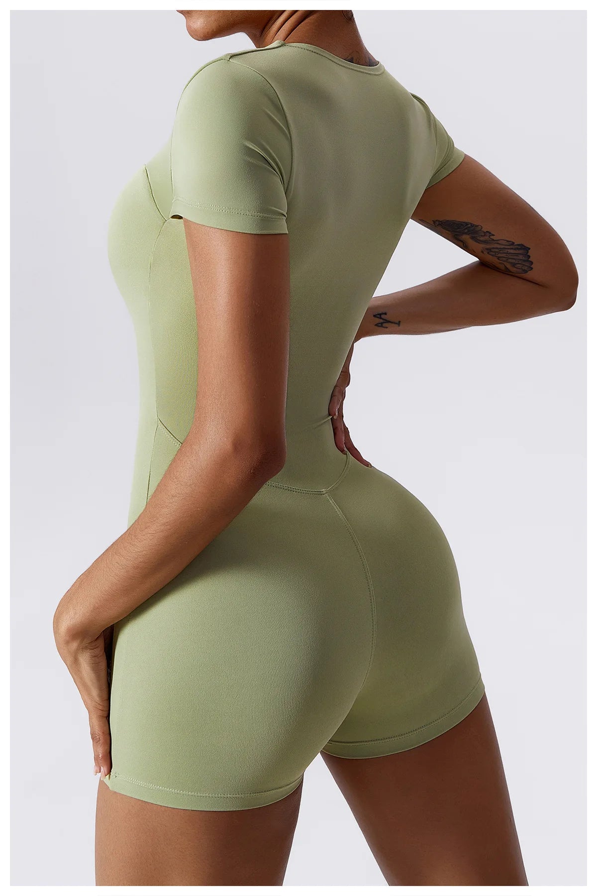Women's olive green short-sleeve yoga bodysuit with fitted shorts