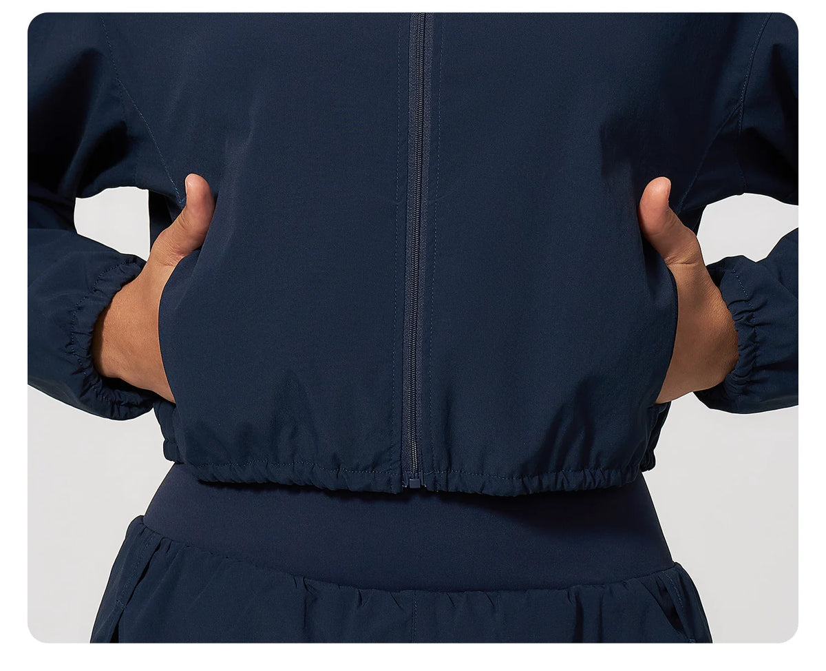 Navy zip-up windbreaker jacket close-up with center zipper and elastic waist