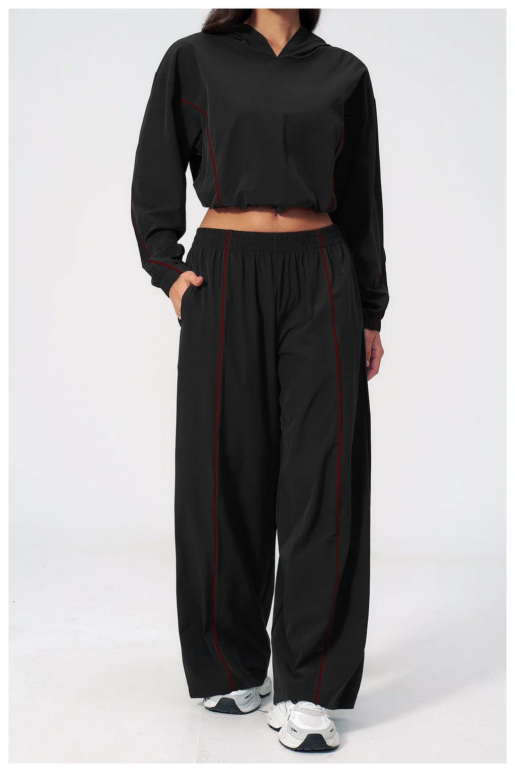 Women’s black hooded cropped windbreaker with red trim and wide-leg pants set