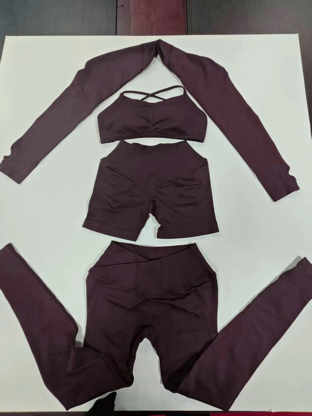 Mocha brown seamless workout set flat lay: shrug, sports bra and leggings
