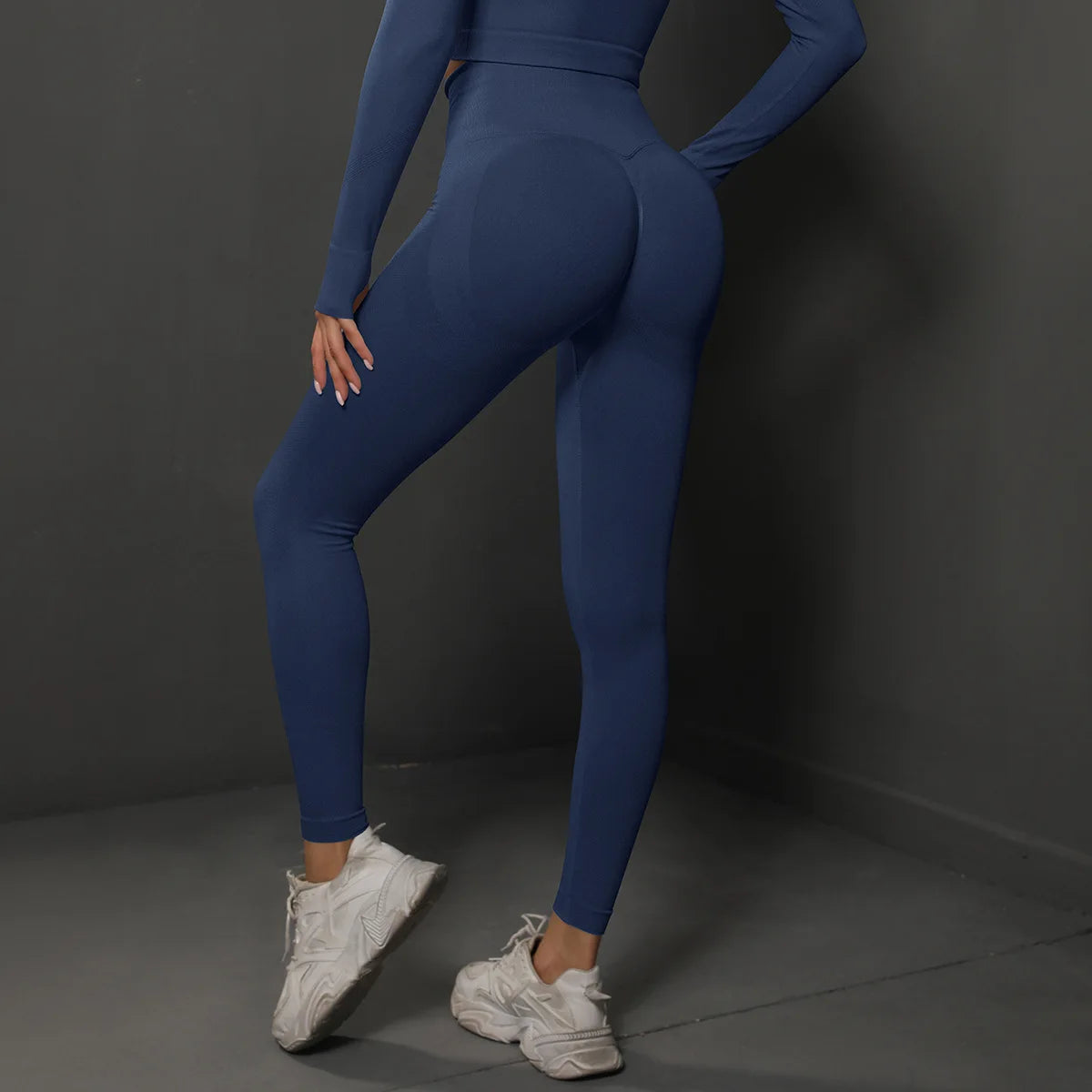 High-waist blue leggings with sculpted back seam detail and fitted ankle-length cut.