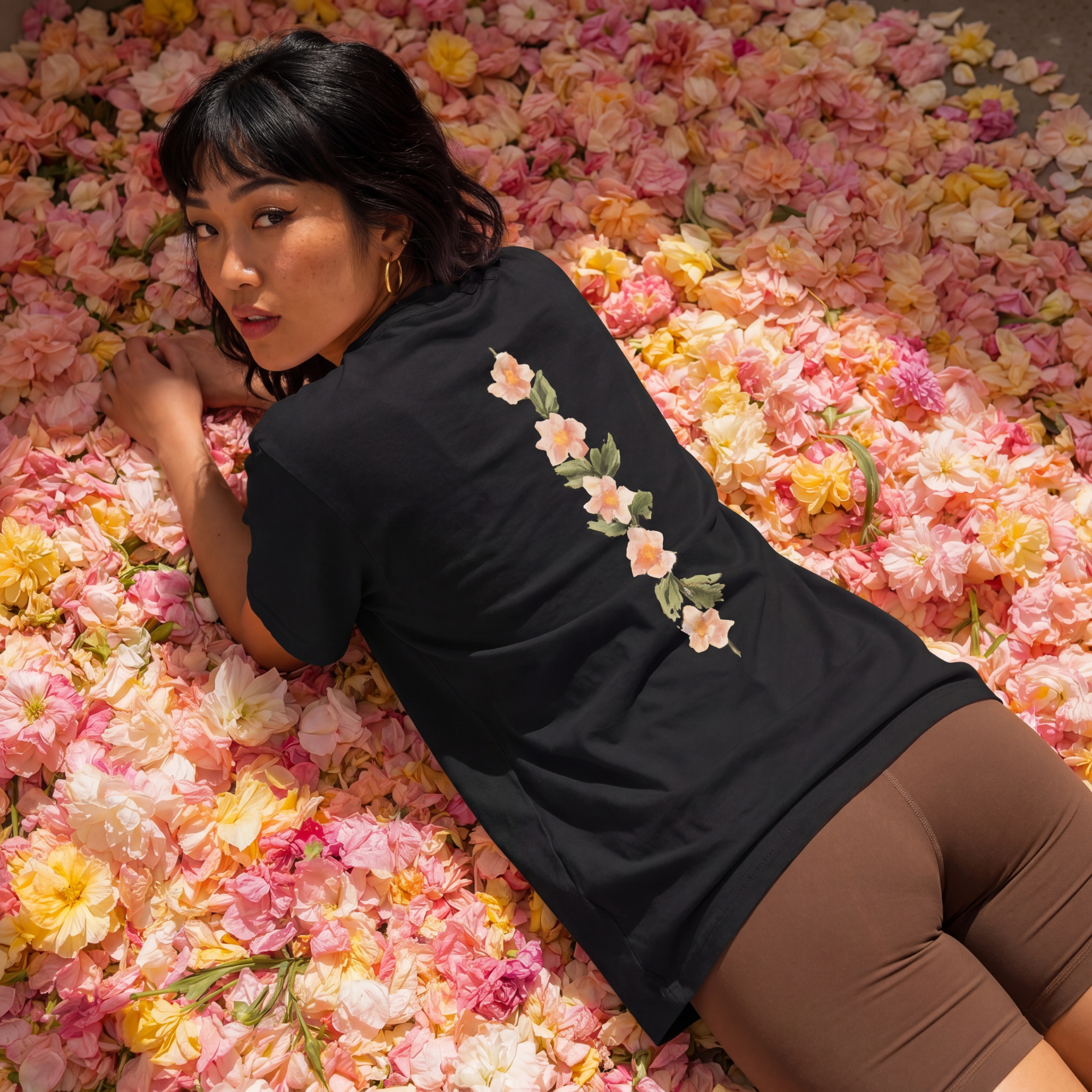 Black crewneck T-shirt with floral graphic detail on the back.
