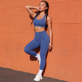 Blue sports bra and high-waisted leggings set, crisscross back straps, full length
