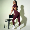 Maroon short-sleeve zip jumpsuit with back cutout and fitted leggings legs