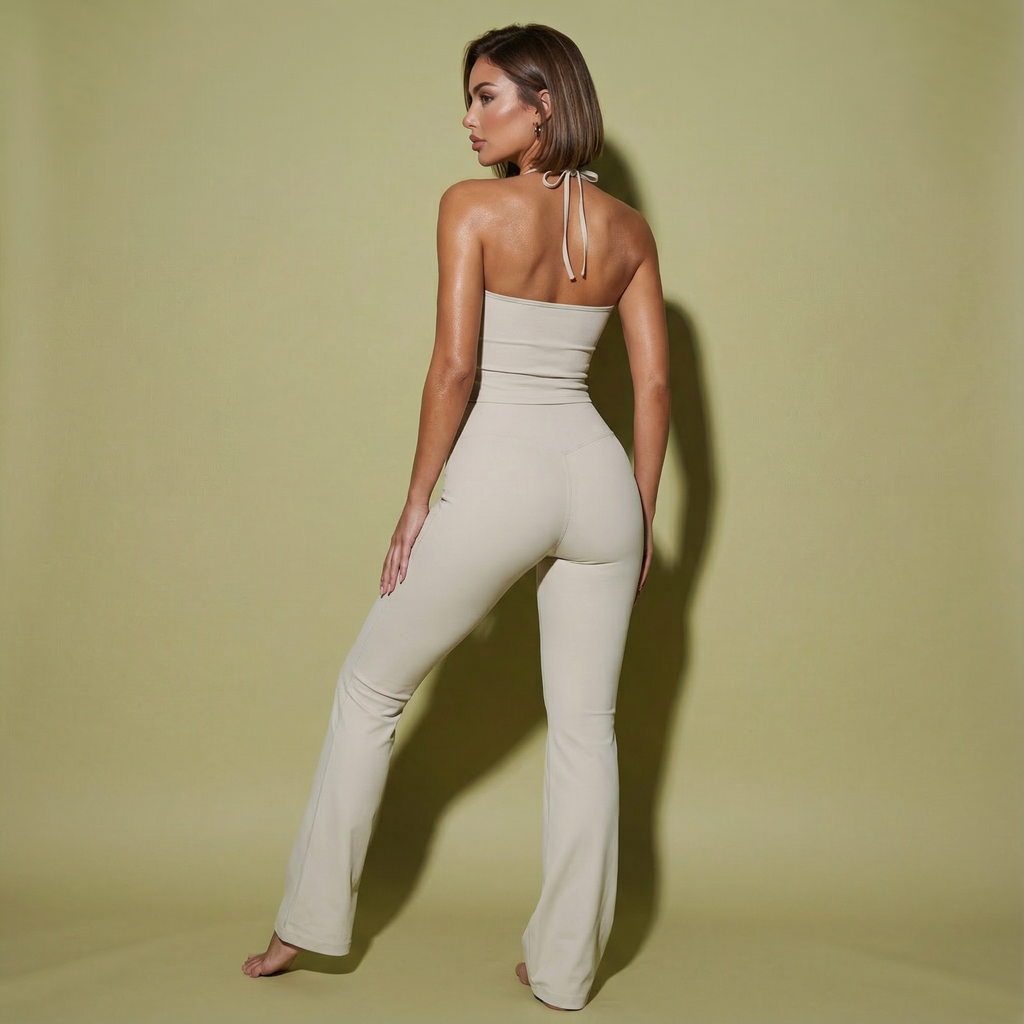 Woman wearing a beige jumpsuit against a solid background