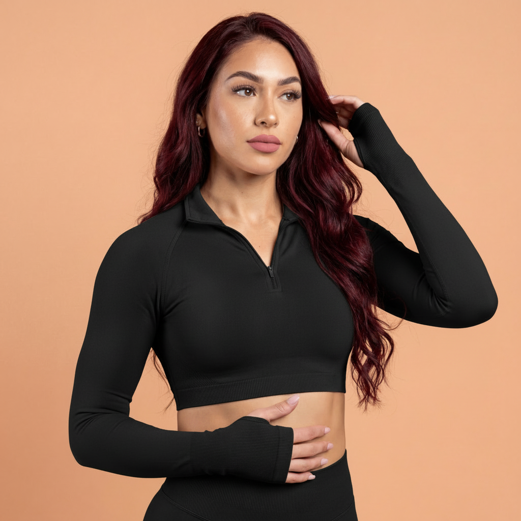 Woman wearing a black long-sleeve crop top against a beige background