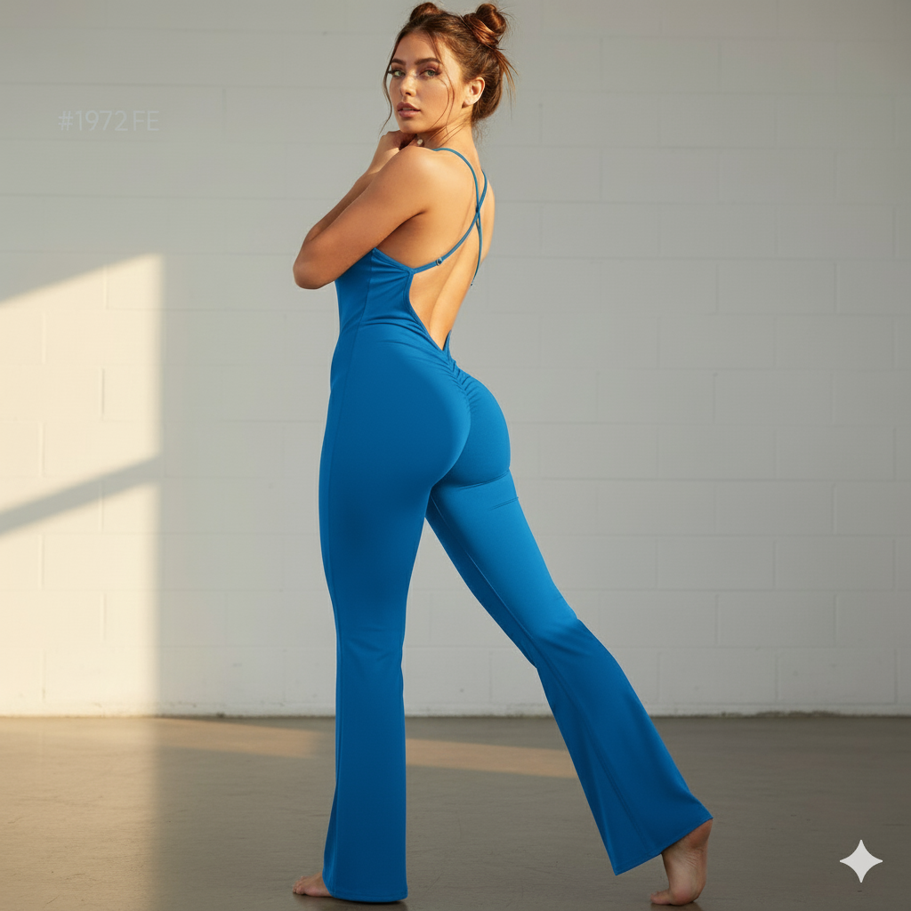 Woman wearing a blue jumpsuit standing against a neutral background