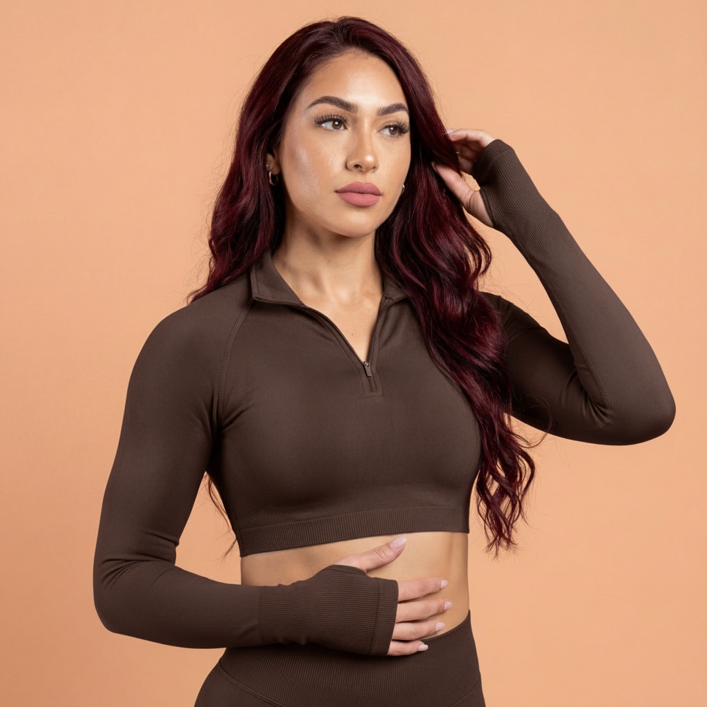 Woman wearing a brown long-sleeve crop top against a beige background