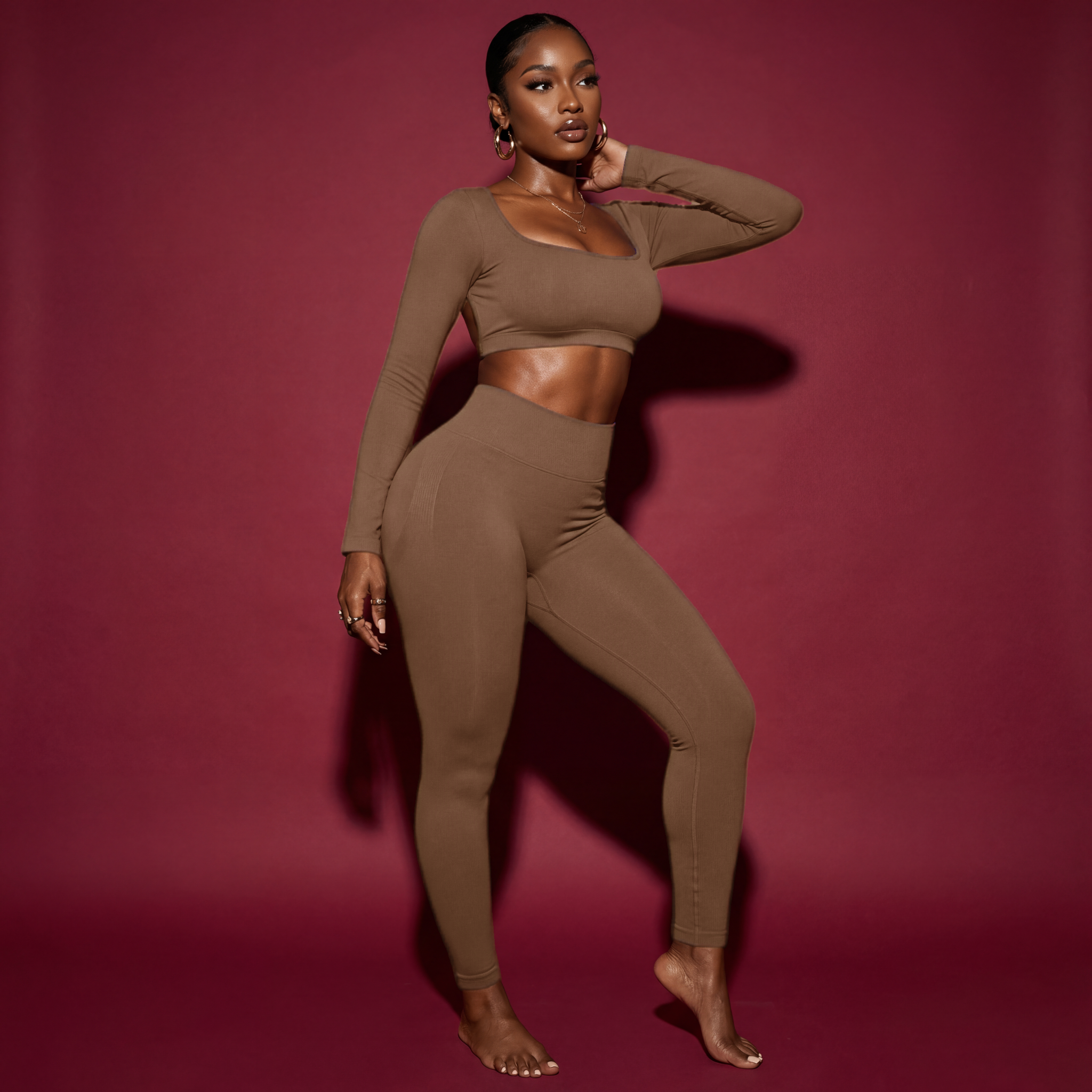 Woman wearing a brown outfit against a red background