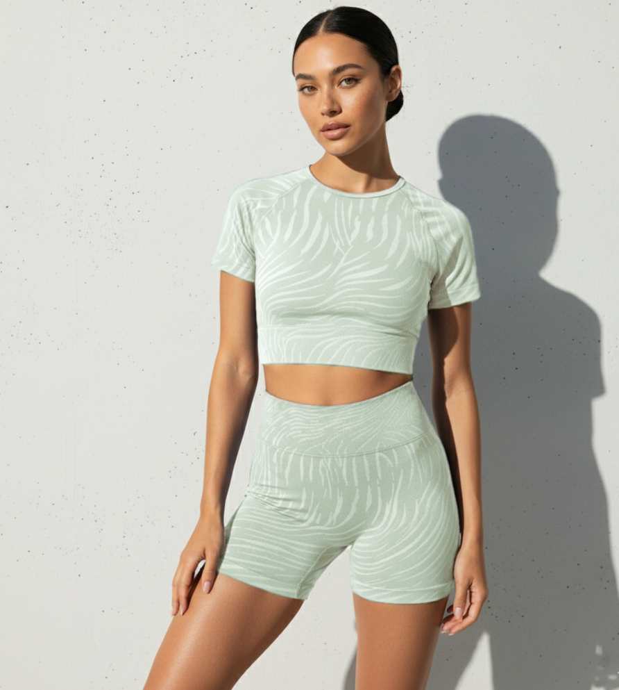 Woman wearing a light green athletic outfit against a white background