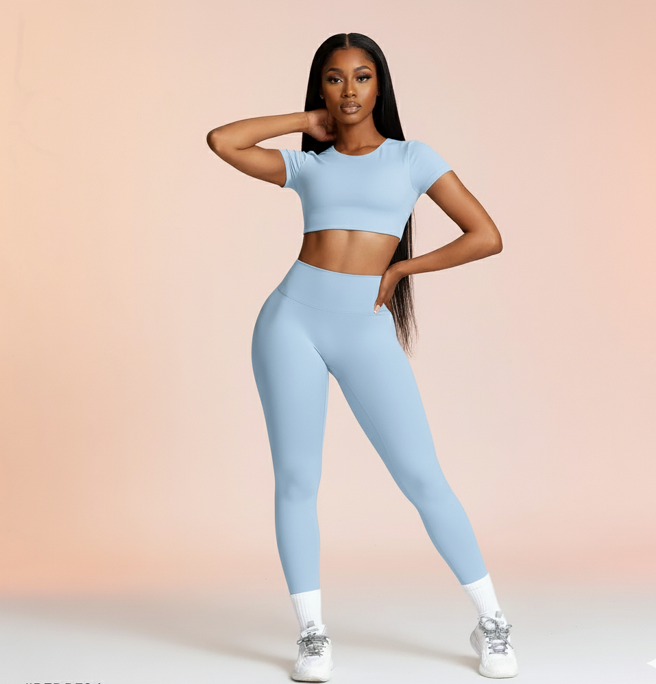 Woman wearing a light blue athletic outfit on a gradient background