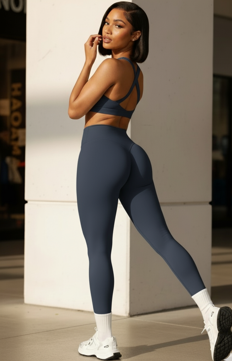 Woman wearing a blue athletic outfit standing against a neutral background