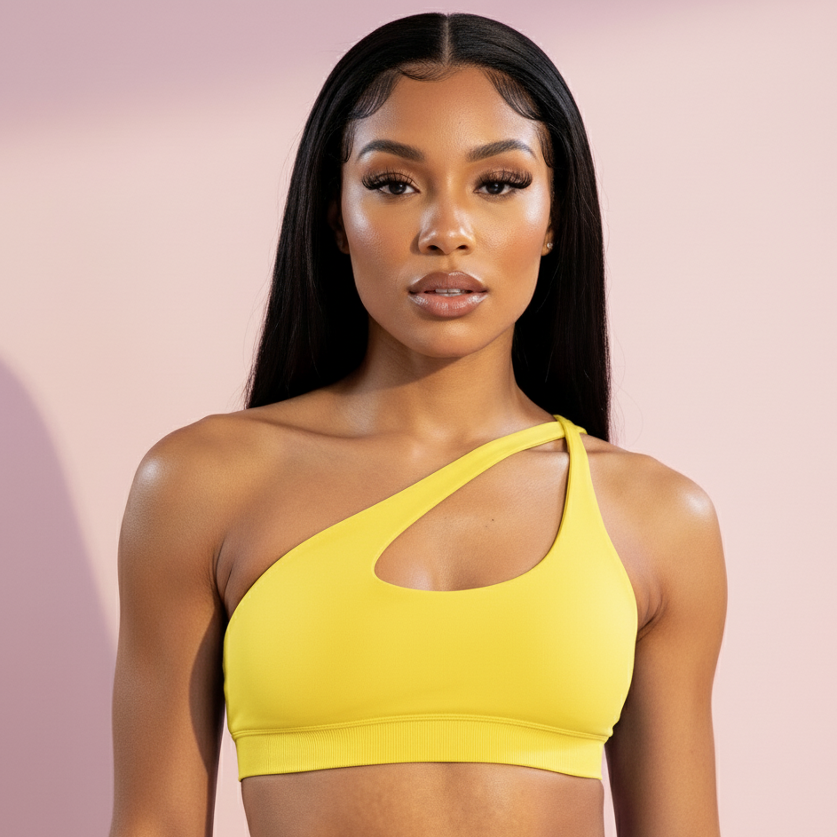 Woman wearing a yellow sports bra against a pink background