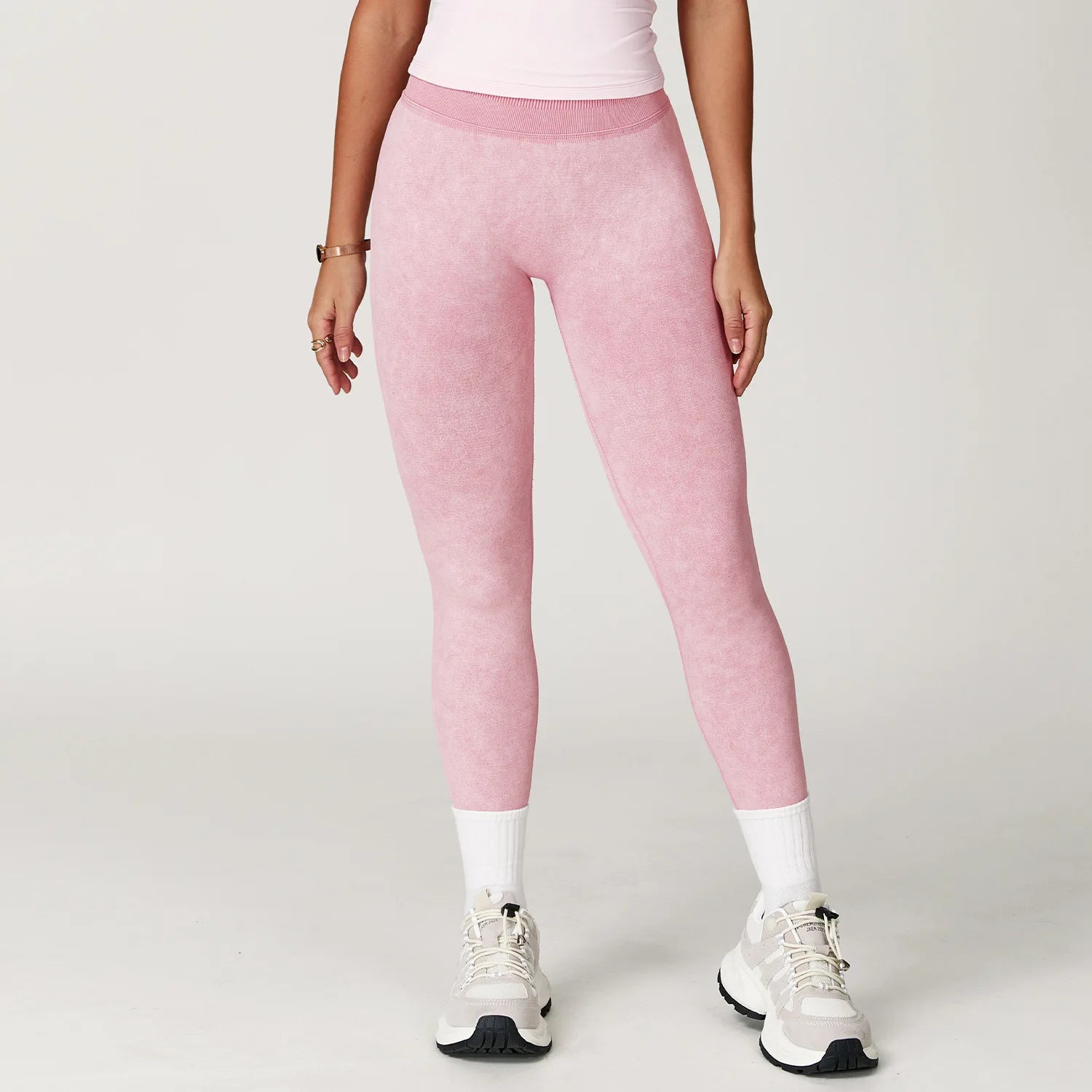 Xooie Fit pink acid wash leggings for women worn with white sneakers and socks