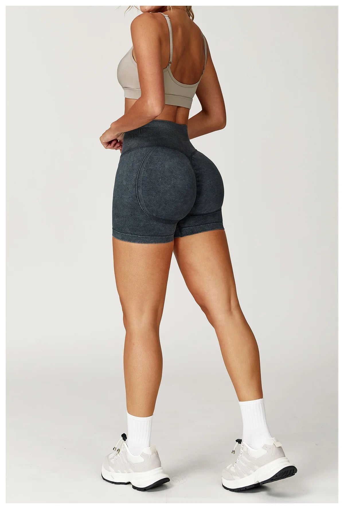 Xooie Fit acid wash workout shorts worn by woman with high waist and contour design