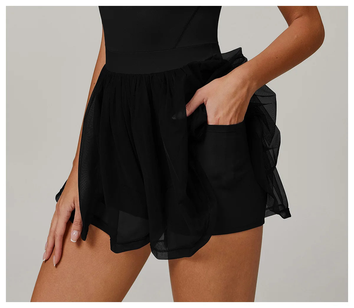 Close-up of black gathered sheer tulle skirt with fitted base