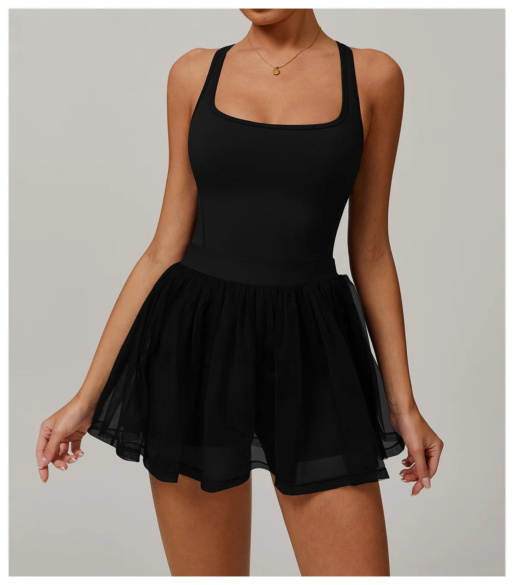 Front view: fitted black active dress with flared sheer tulle skirt