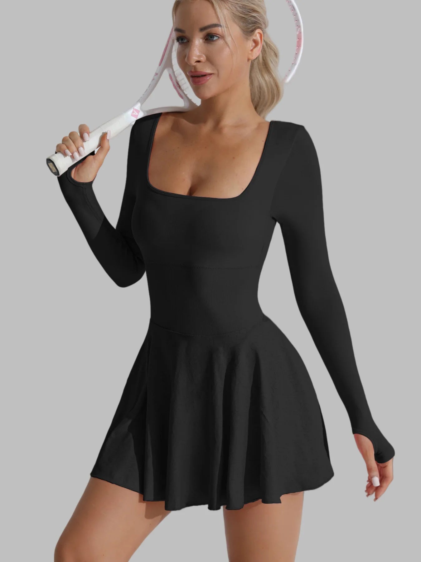 Black long-sleeve active dress, open X-back straps, flared skater skirt and built-in shorts.
