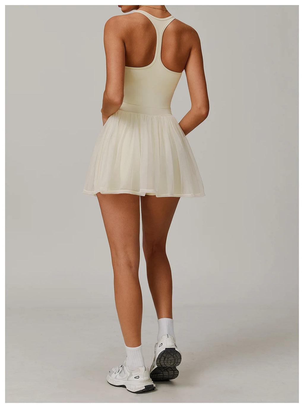 Light ivory back view active dress with racerback and sheer pleated mini skirt