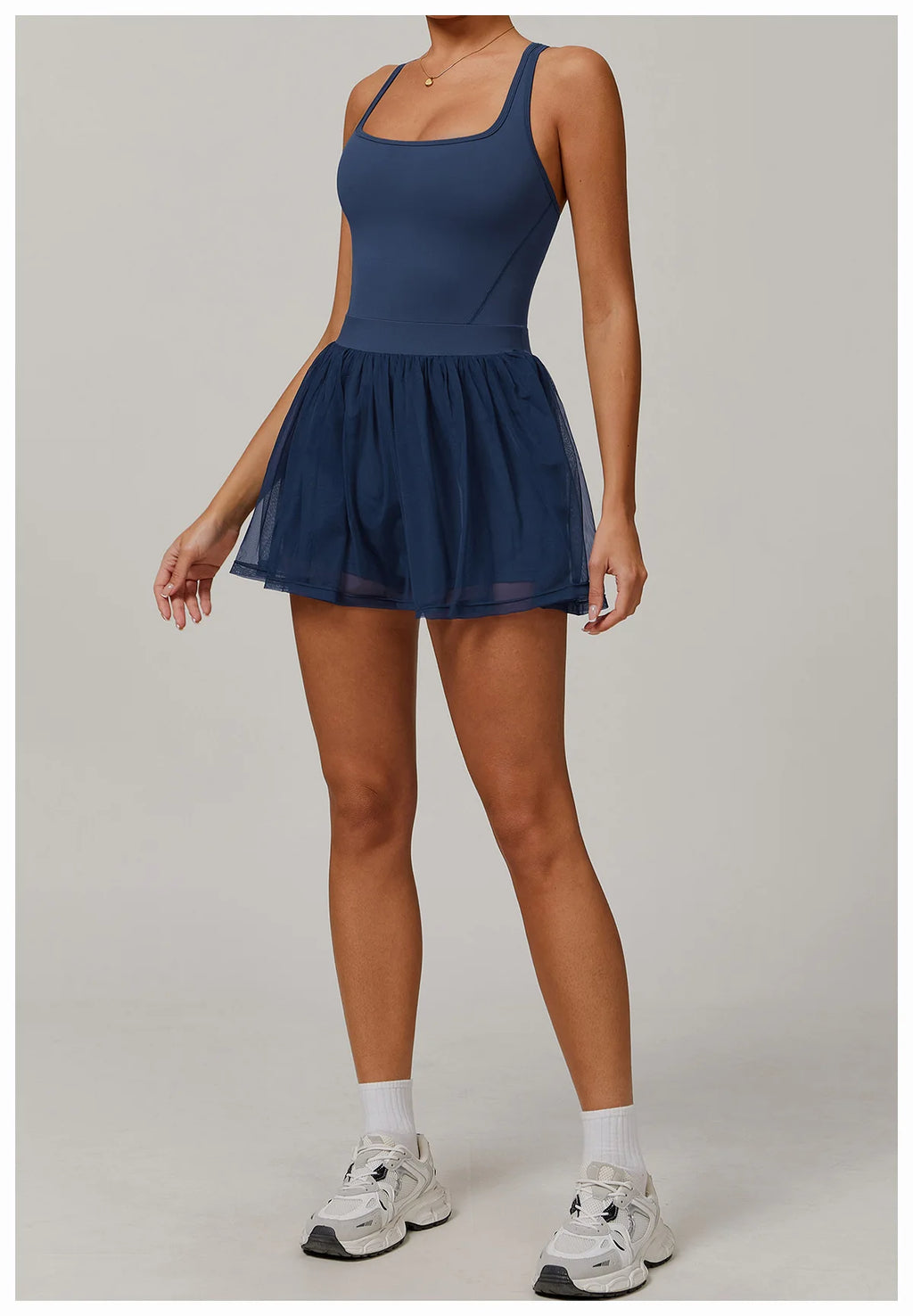 Navy blue sleeveless active dress with gathered tulle mini skirt overlay