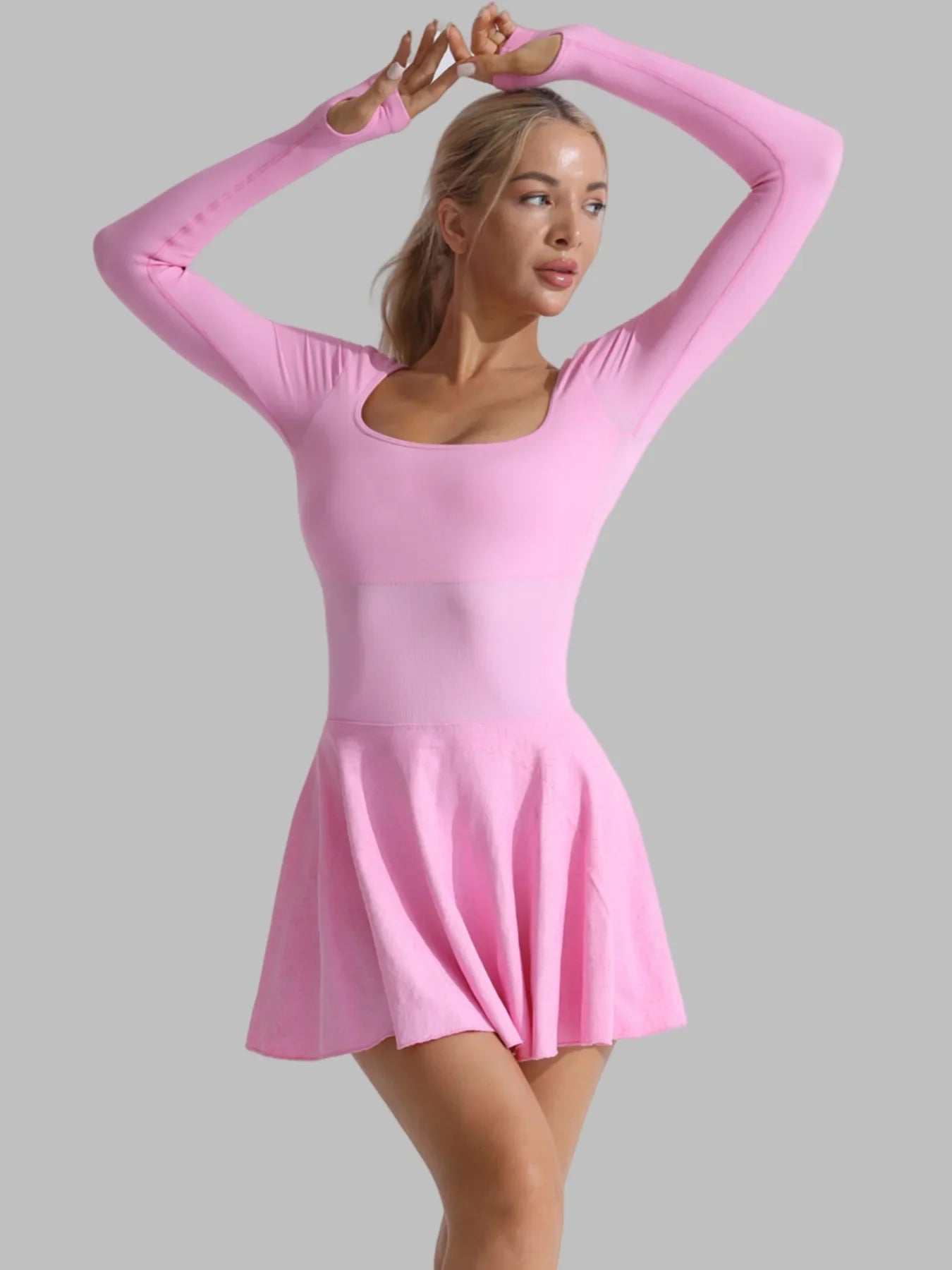 Pink long-sleeve active dress, flared skater skirt and built-in shorts; stretch fit.
