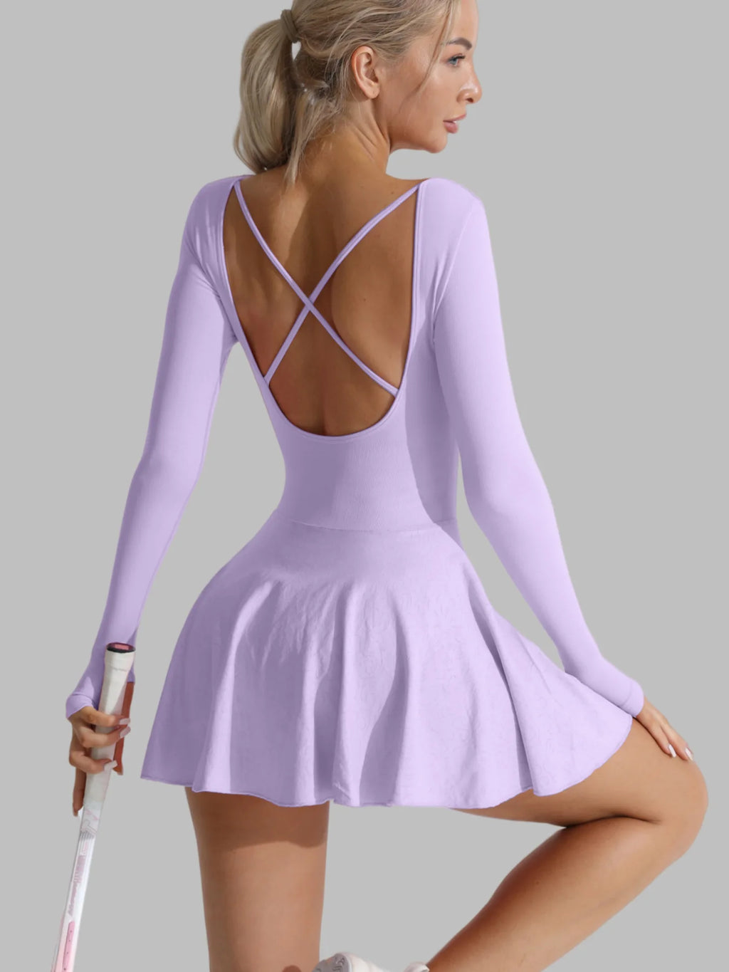 Light purple long-sleeve active dress with open X-back straps and flared skirt