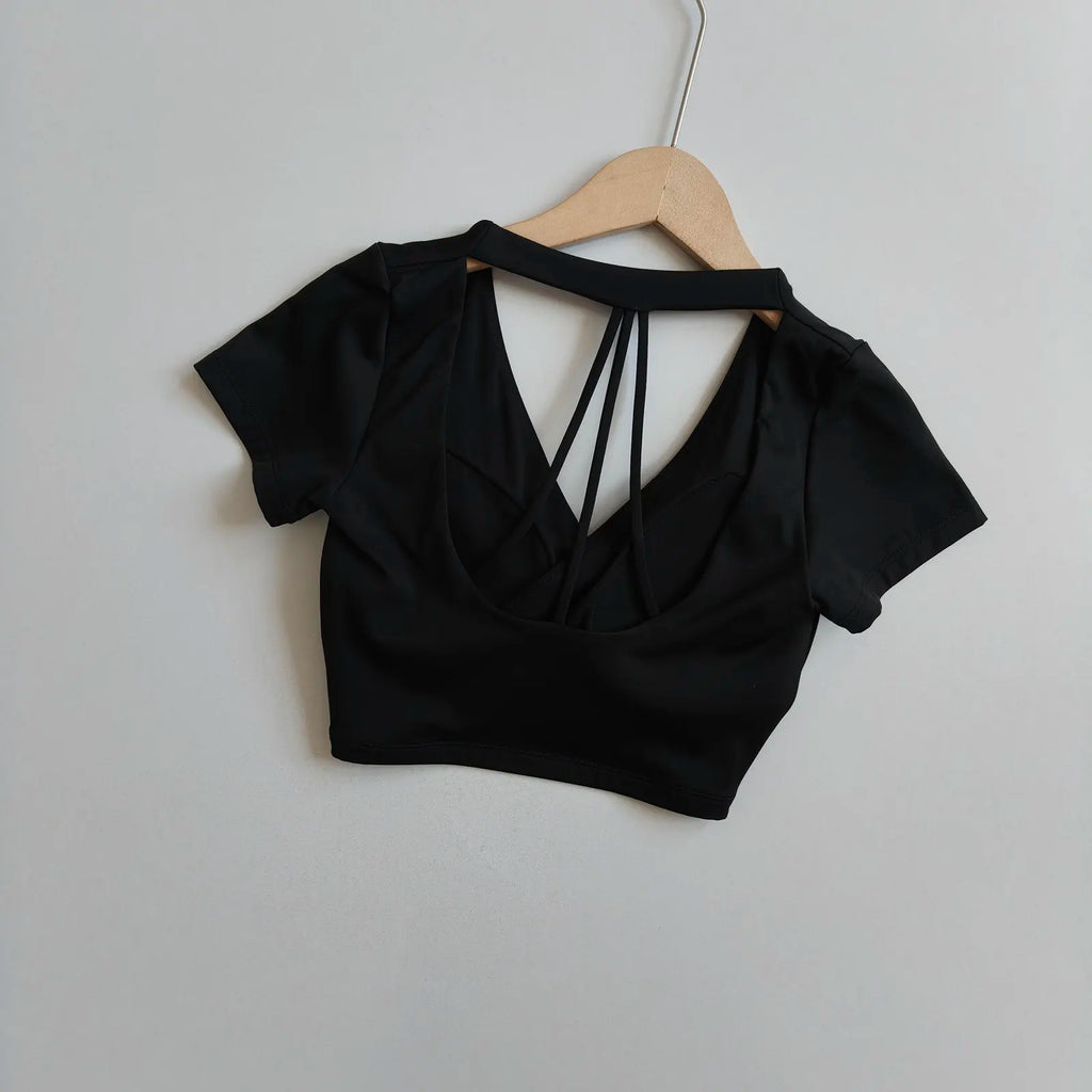 Black short-sleeve wrap crop top with crisscross open back and V-neck front