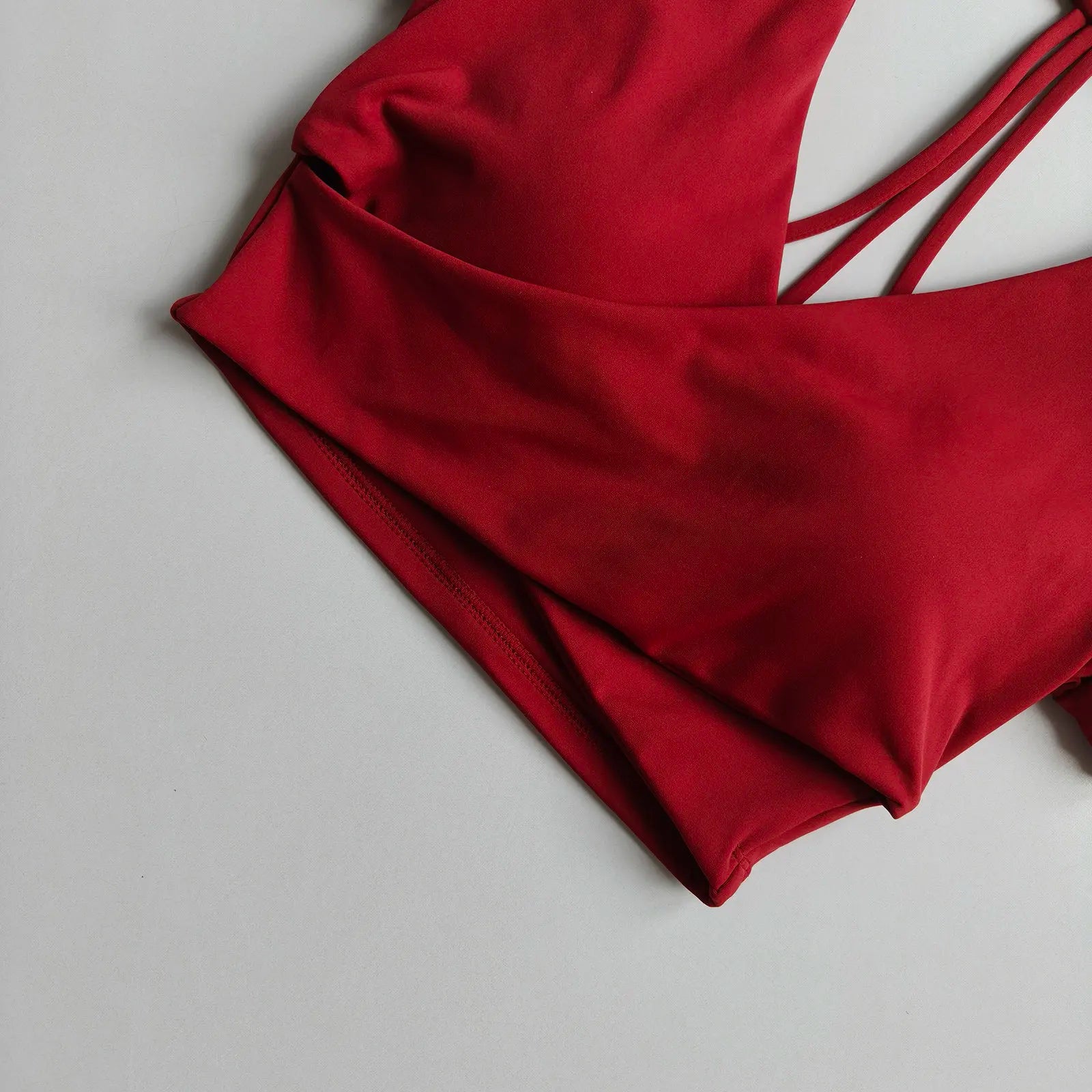 Wine red cross-over active crop top close-up with strappy back detail