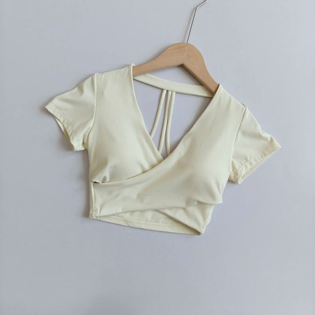 White short-sleeve cross-over active crop top with crisscross open back straps