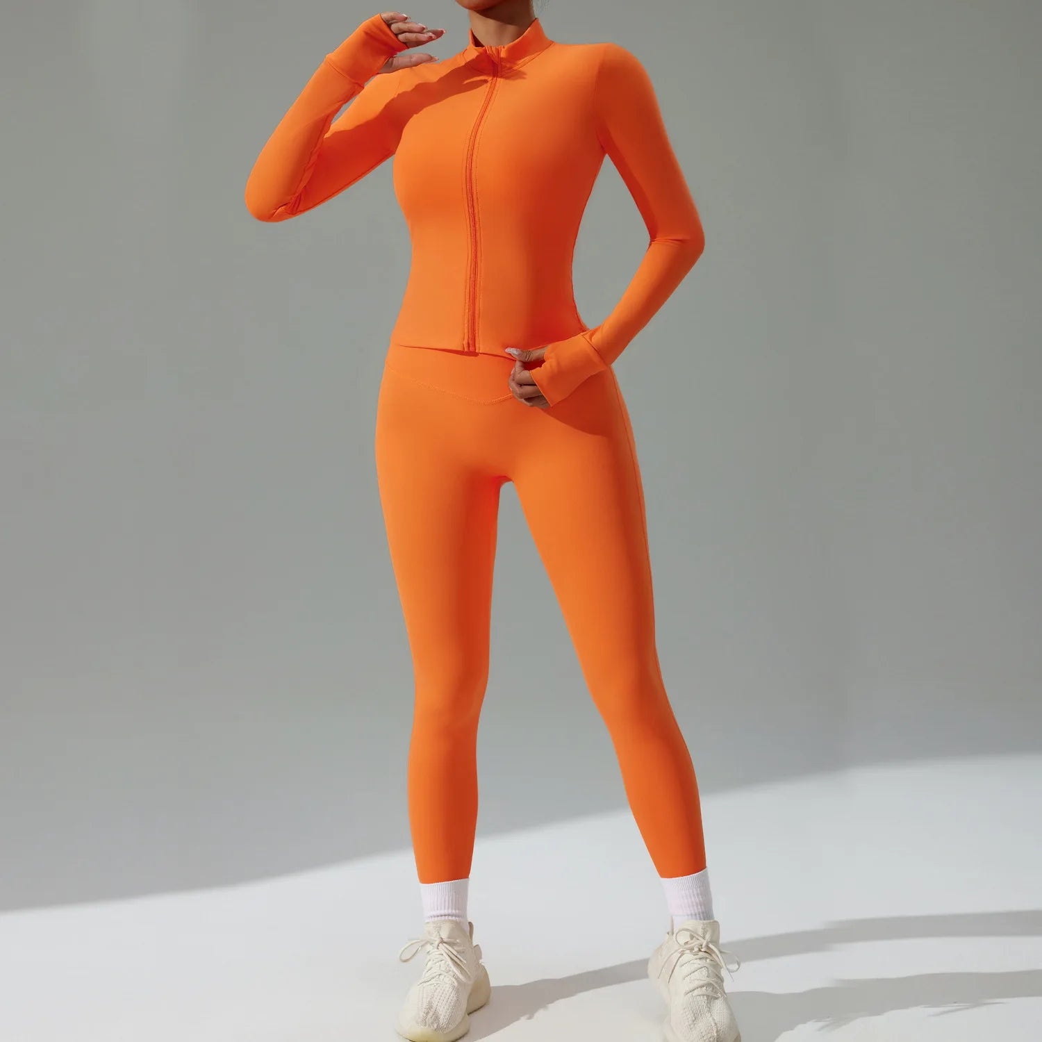 Xooie Fit 3-piece activewear set in vibrant orange with full zip design for comfort and style
