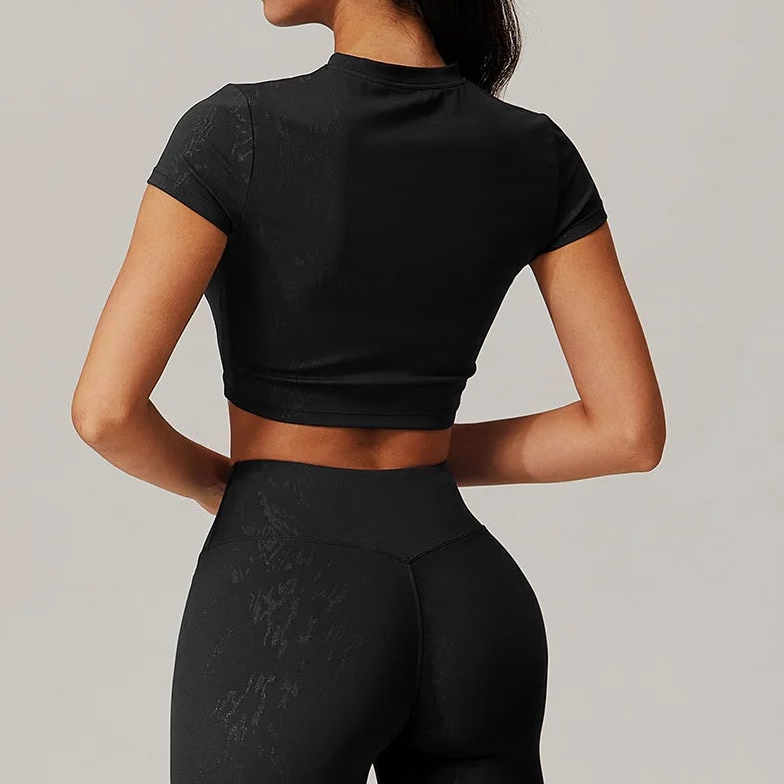 Black matching active crop top and high-waist shorts shown from the back