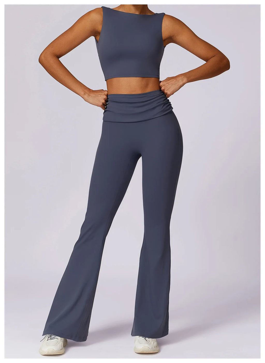 Women’s navy sleeveless sports bra crop top with ruched waist and flared leggings