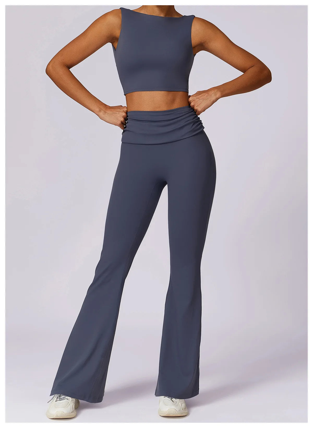 Women’s navy sleeveless sports bra crop top with ruched waist and flared leggings