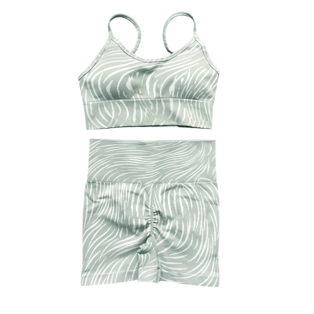 Xooie Fit high-performance activewear bra and shorts set in green with a stylish wave pattern