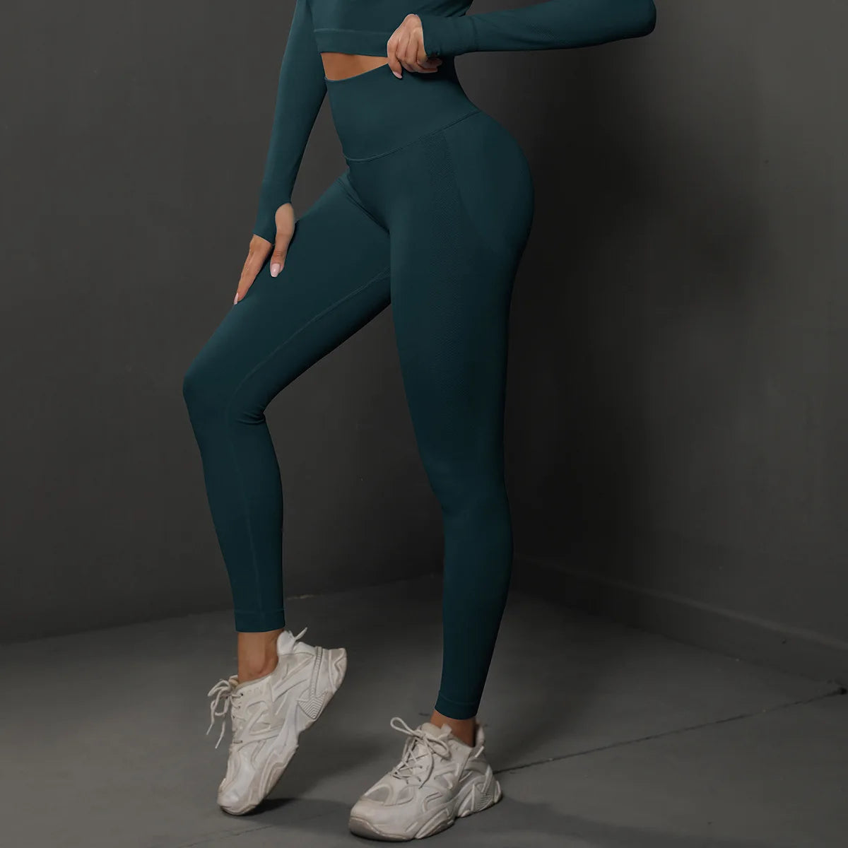 High-waist yoga leggings, dark teal, side view with fitted ankle length