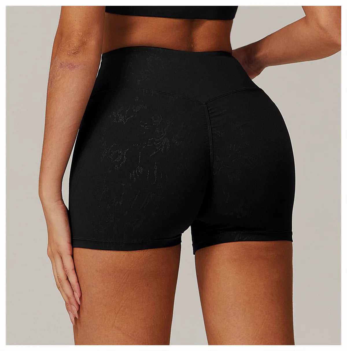Xooie Fit black animal print active shorts with high waist and subtle pattern on model from back