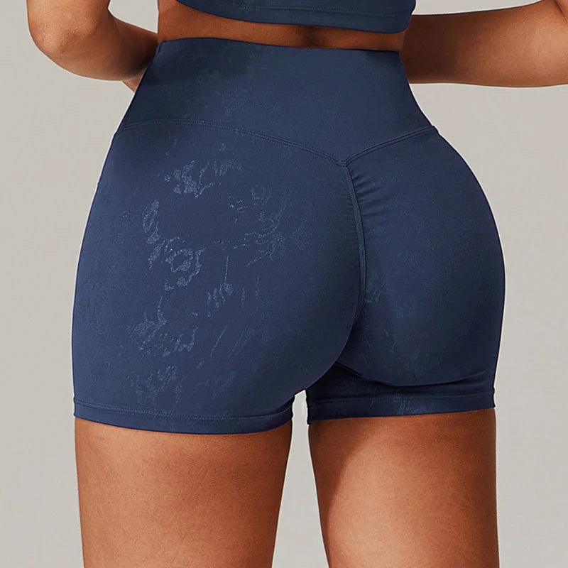 Xooie Fit navy animal print active shorts with high waist and snug fit on model