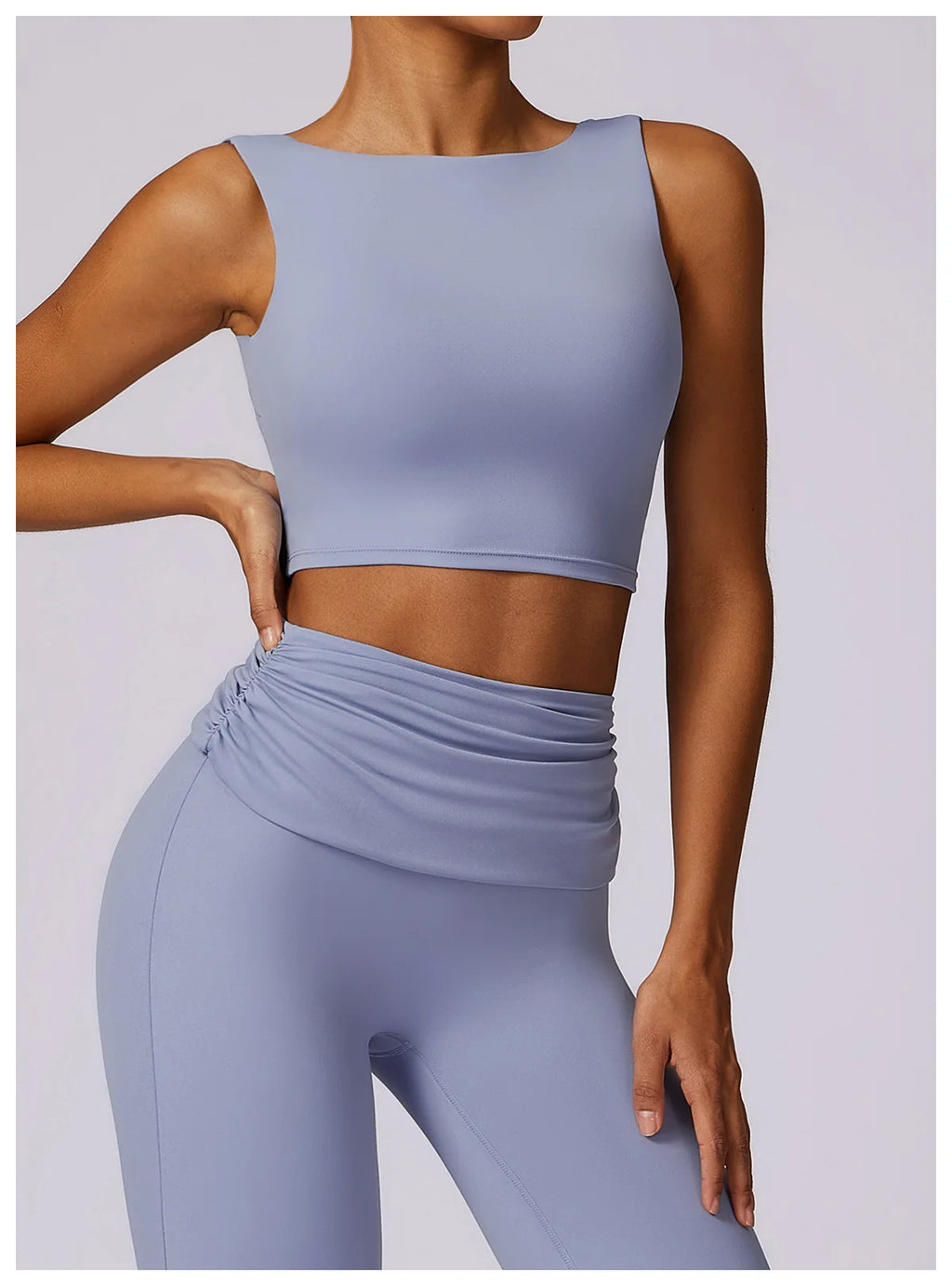Light blue sleeveless sports bra crop top with straight neckline and smooth fabric.