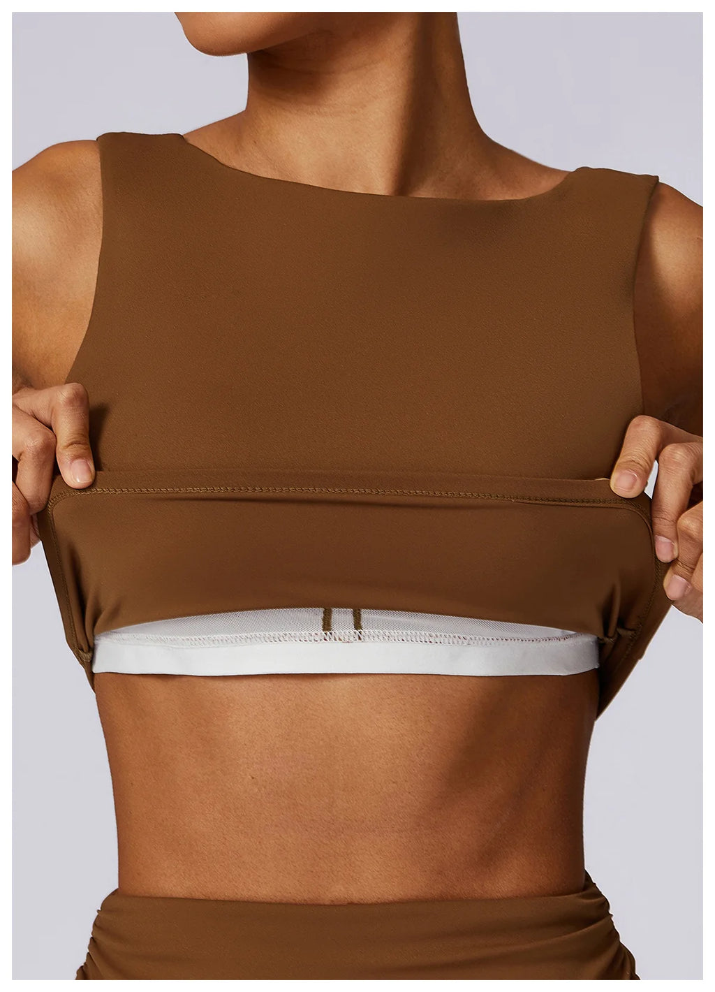 Brown backless sports bra crop top with wide elastic hem and smooth front.