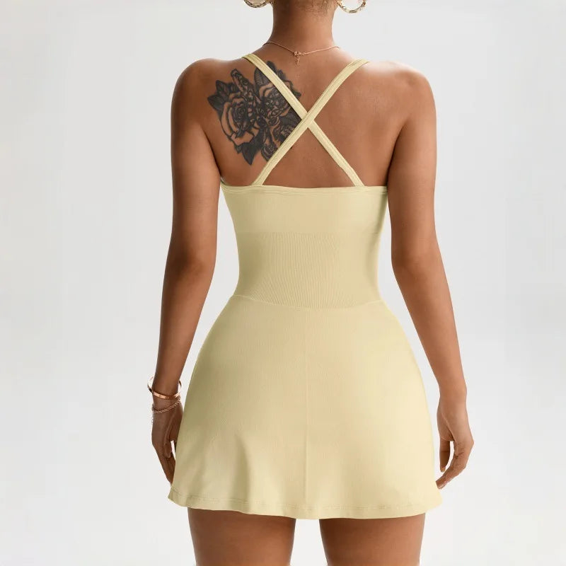 Women's tennis skort dress back view in pale yellow, crisscross strap detail