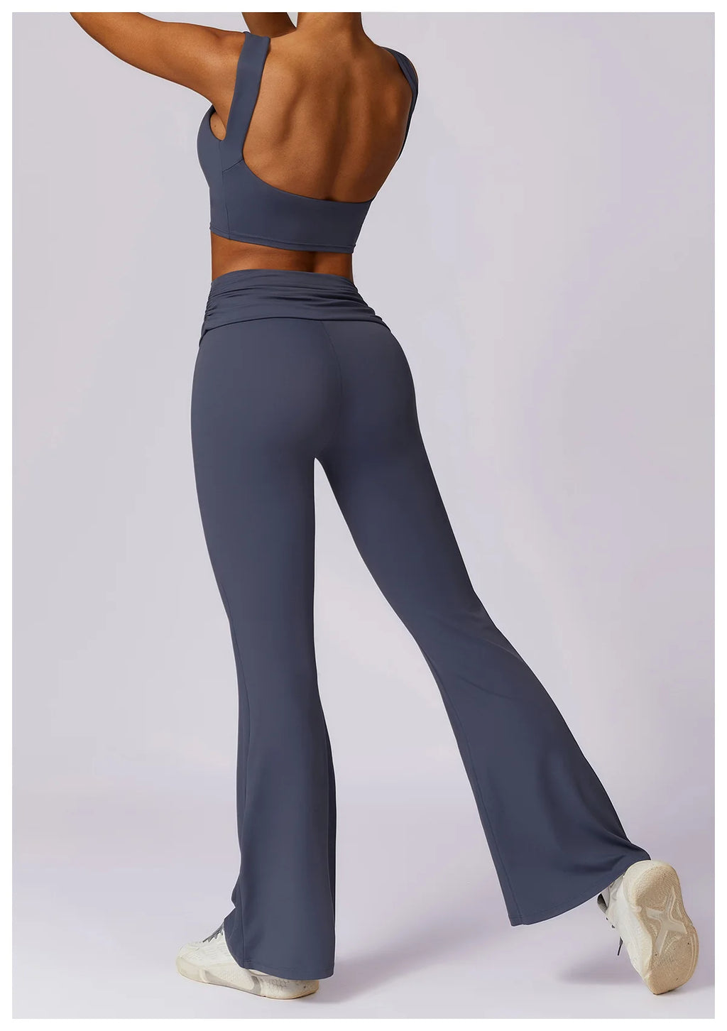 Women’s navy sports bra and flared wide-leg leggings, side view