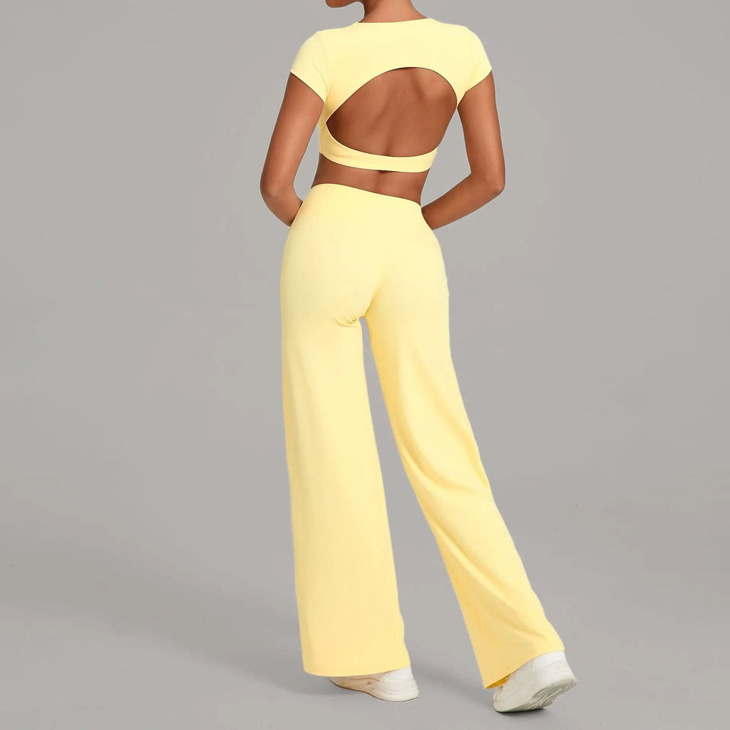 Xooie Fit backless crop top and flare pants set in yellow, showcasing a stylish open back design