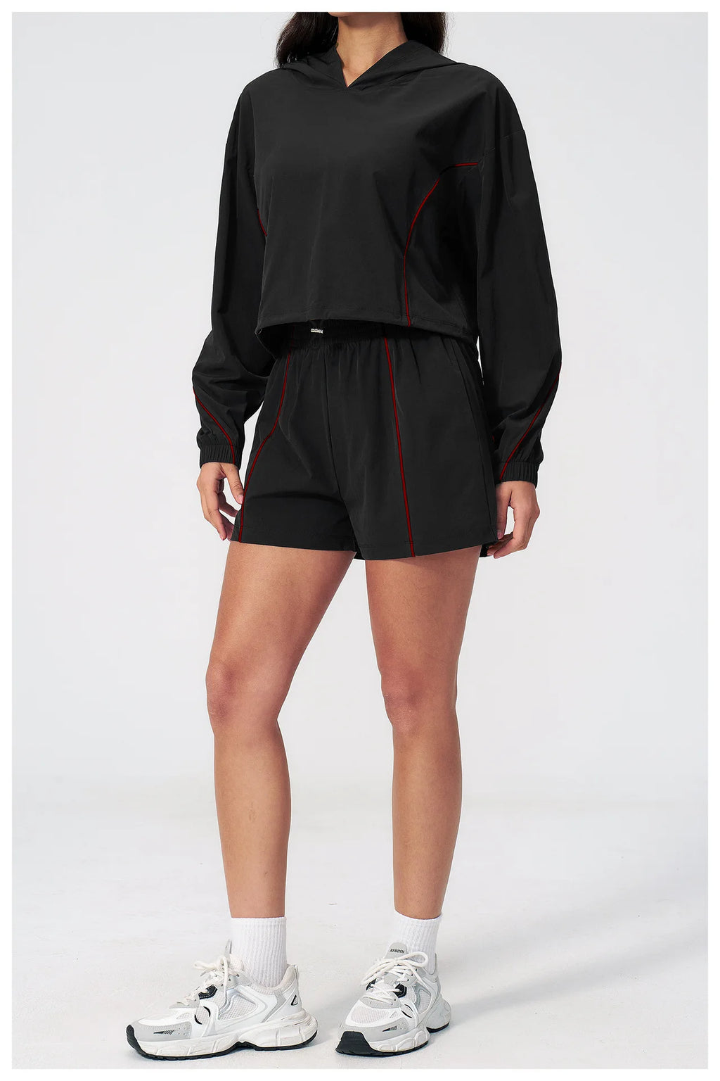 Women’s hooded sports set in black, cropped jacket and matching shorts with red piping