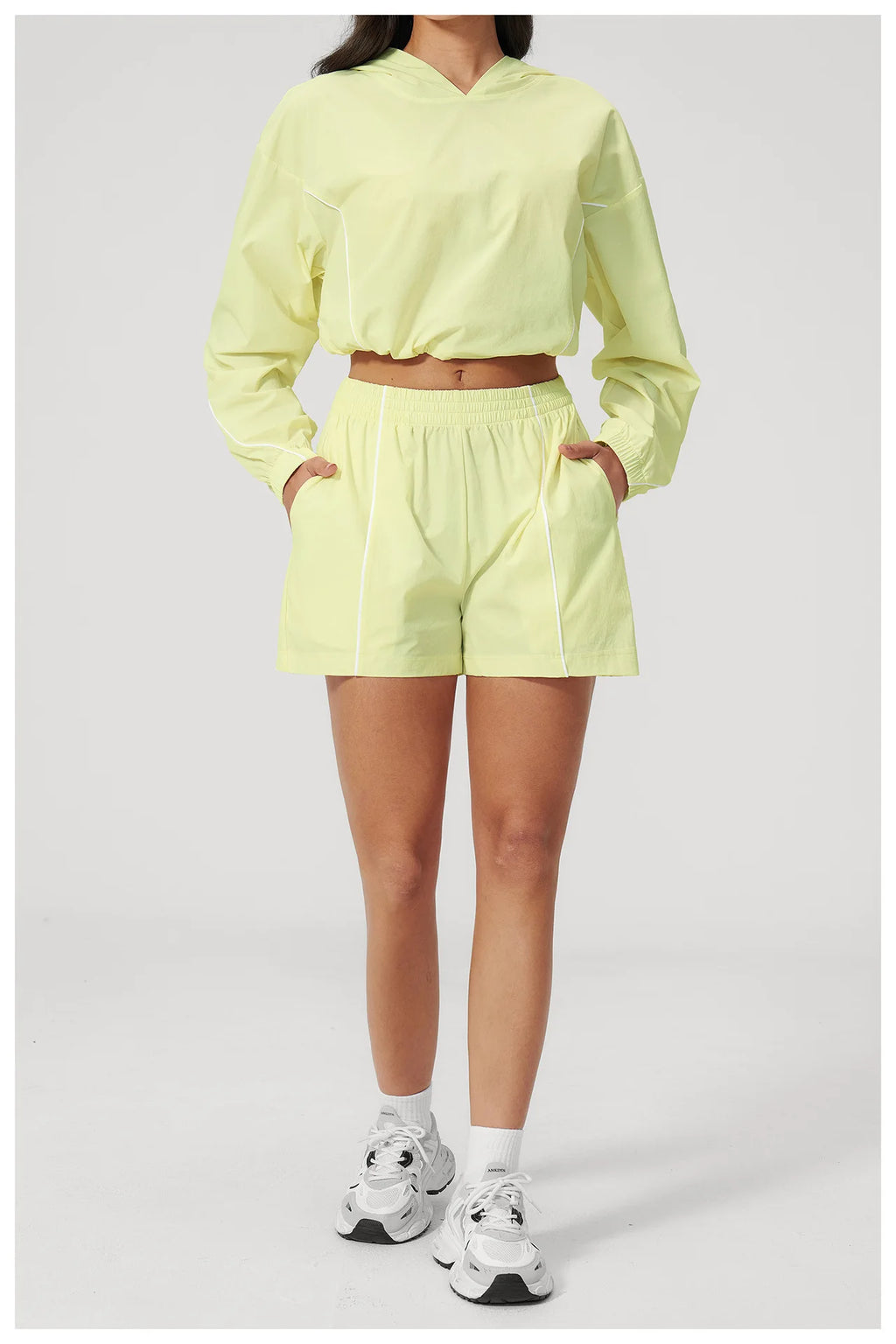Women’s hooded sports set, light yellow jacket and shorts with elastic waistband