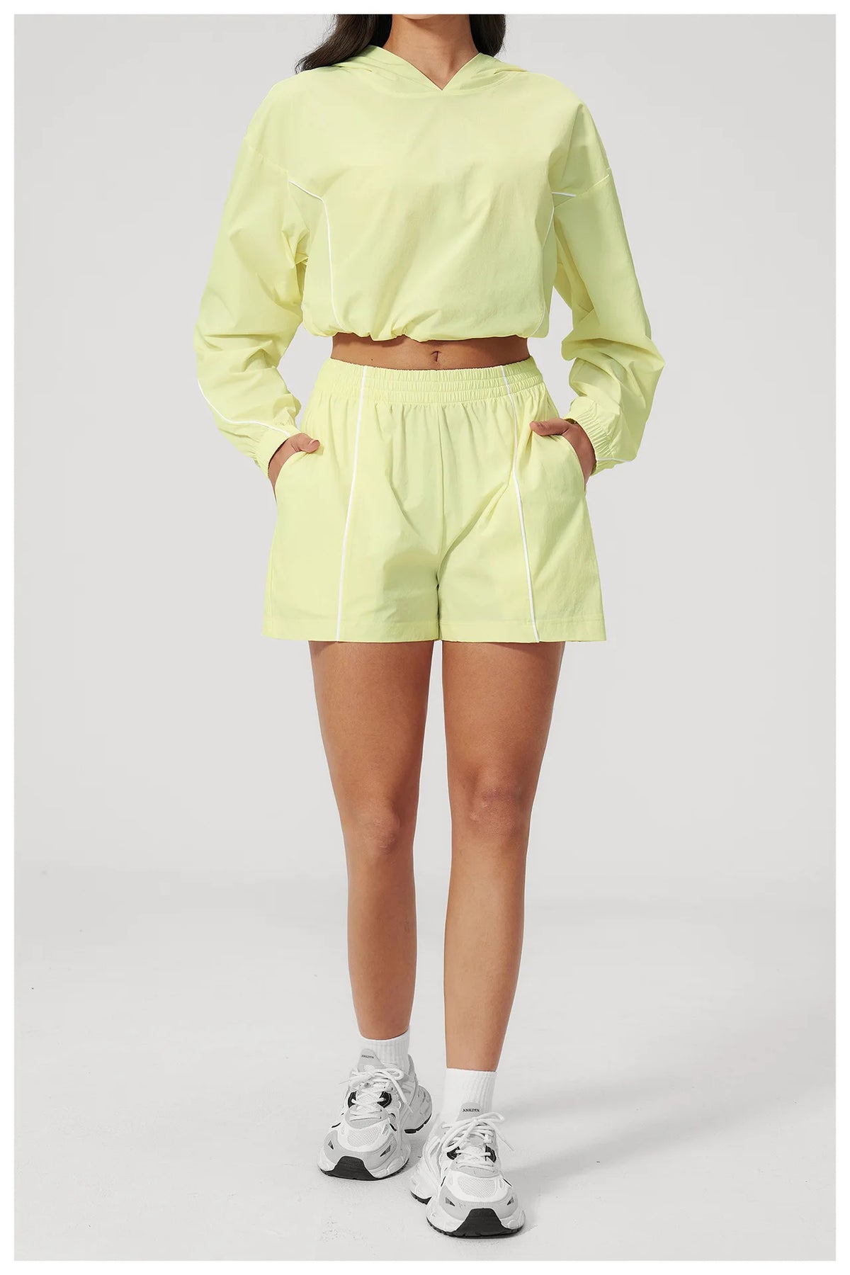 Women’s hooded sports set, light yellow jacket and shorts with elastic waistband