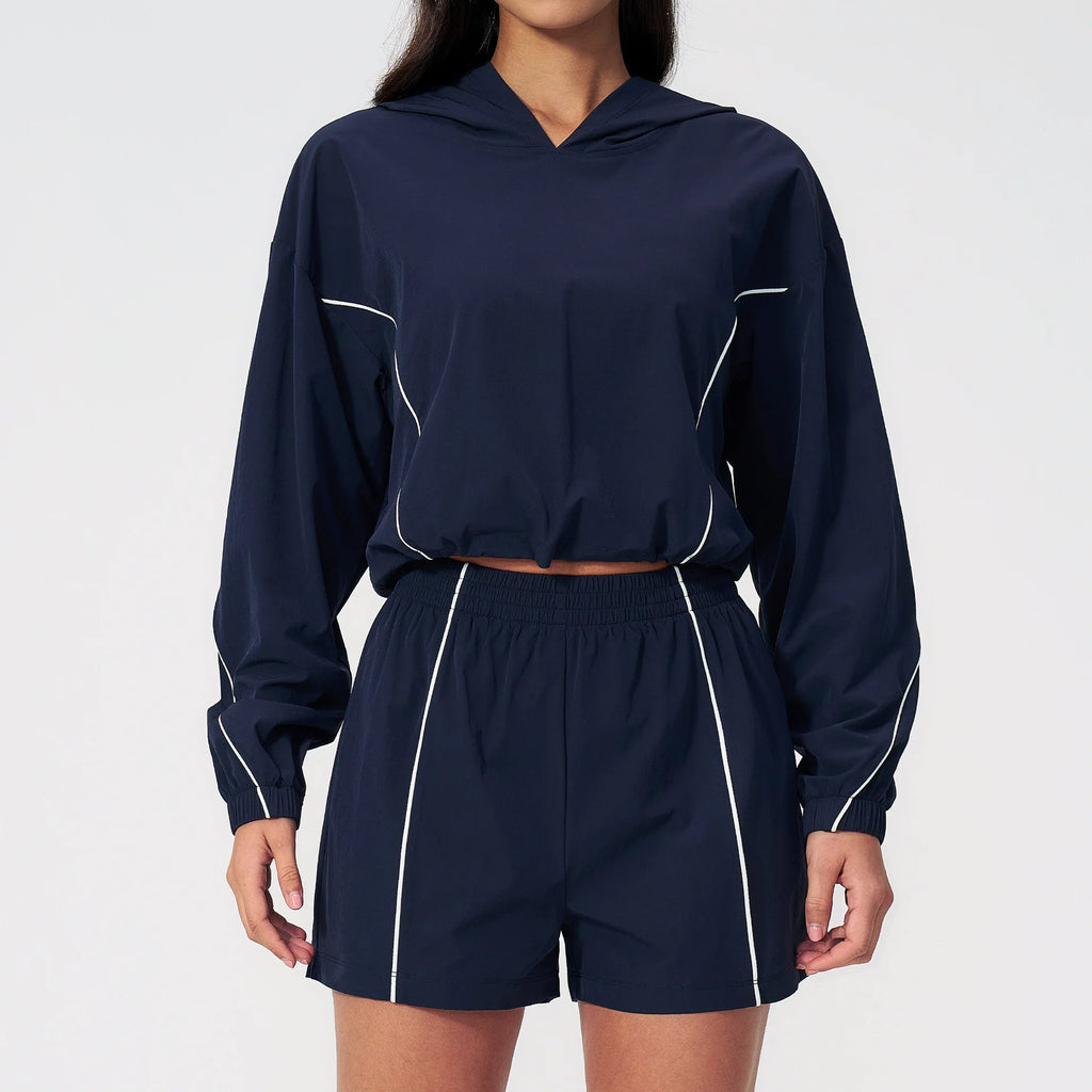 Women’s hooded sports set in navy blue, cropped jacket with white piping and shorts
